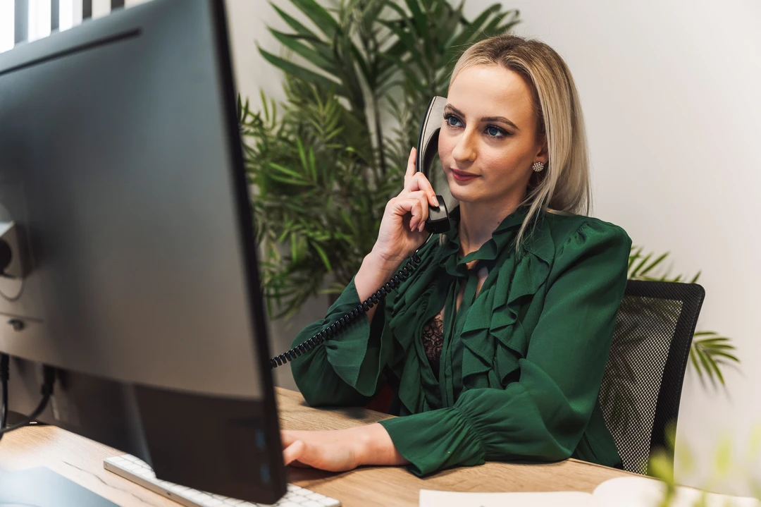 A professional woman in a green blouse